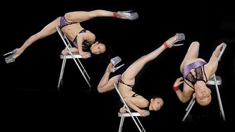 Pole dancer performing a chair dance sequence to develop fluidity, flow, and seamless transitions.