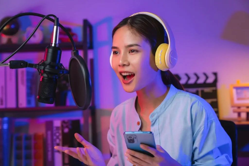 a pole dancer with a microphone recording a podcast